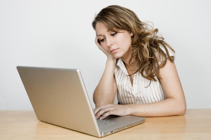 unhappy woman using laptop