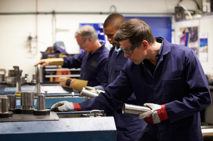 Men working in engineering factory