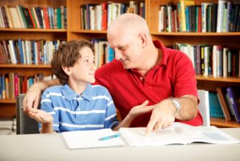 Father and son reading a book