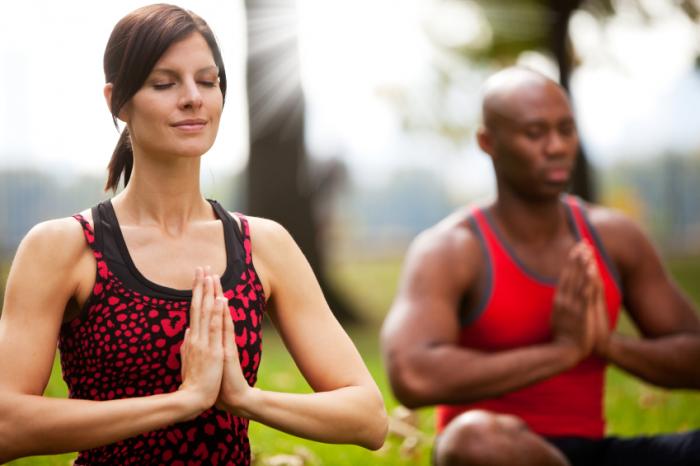 man and woman in a yoga pose