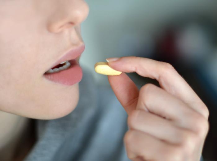 woman taking a pill