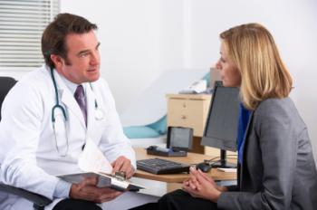 male doctor talking to female patient