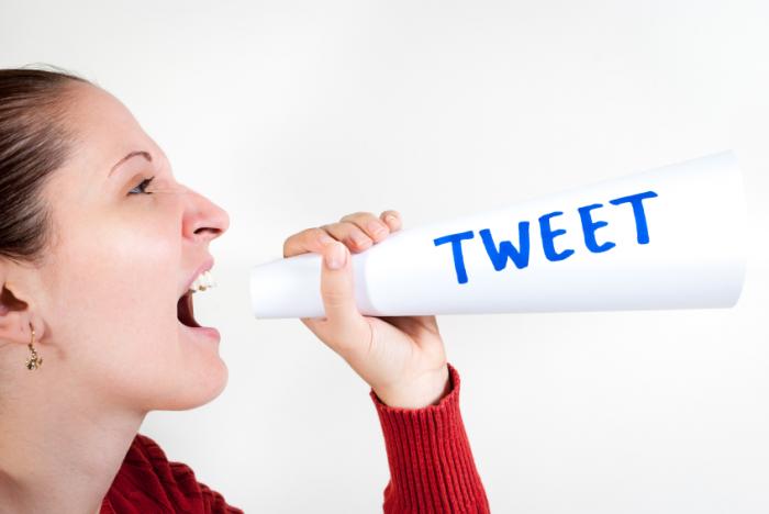 A woman shouting an angry tweet