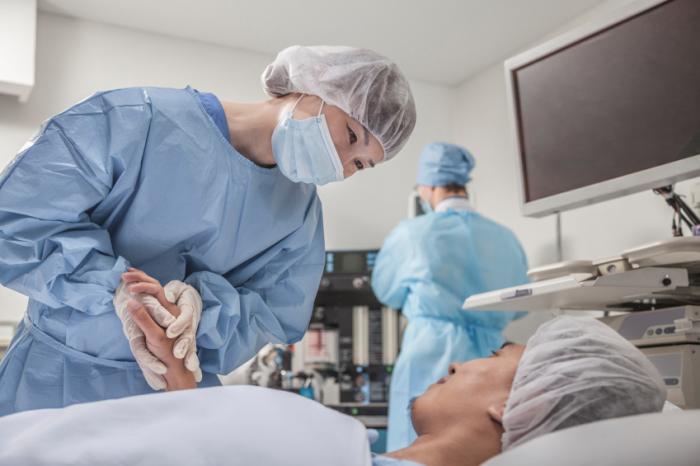 surgical health care professionals with patient before operation