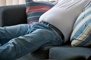 overweight man sitting on sofa